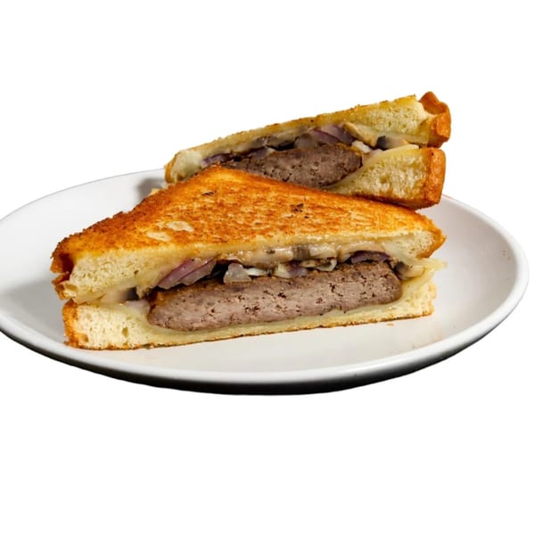 Country Smokin Burgers' patty melt, cut in half, with grilled onions and melted cheese on toasted bread.